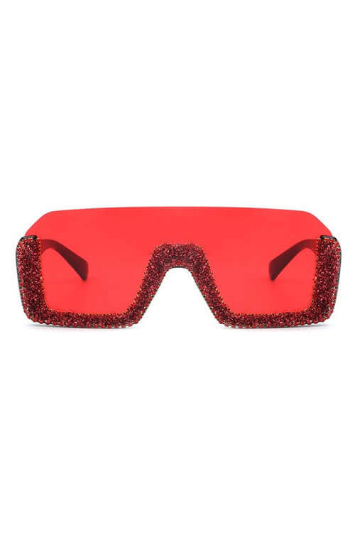 Oversized red eclipse shades with glittery edges and bold mirrored lenses for stylish UV protection.