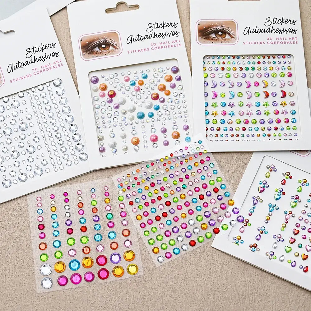 Collection of colorful nail art stickers featuring various rhinestones and designs.