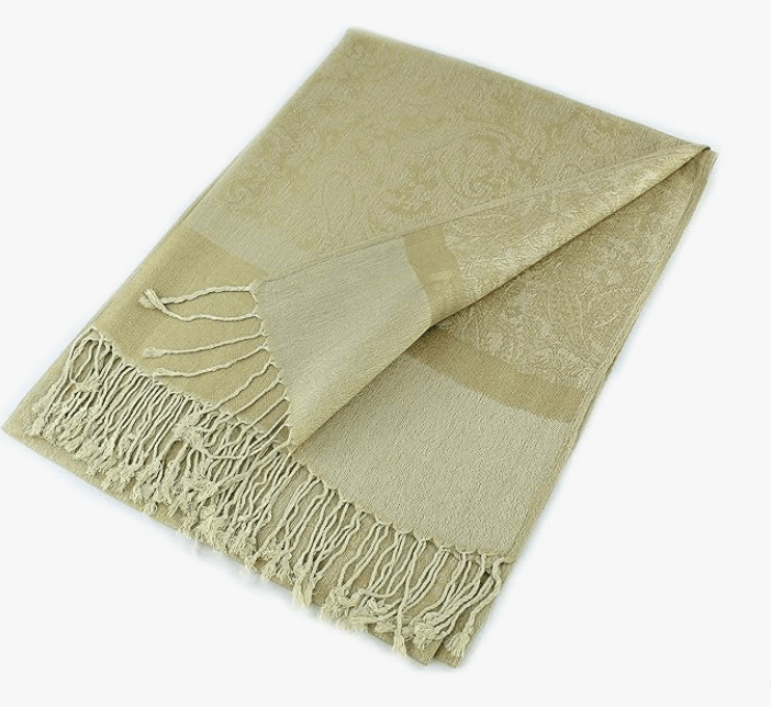 Luxurious beige Celestial Luxe Pashmina wrap with intricate design and hand-knotted tassels for elegant styling.