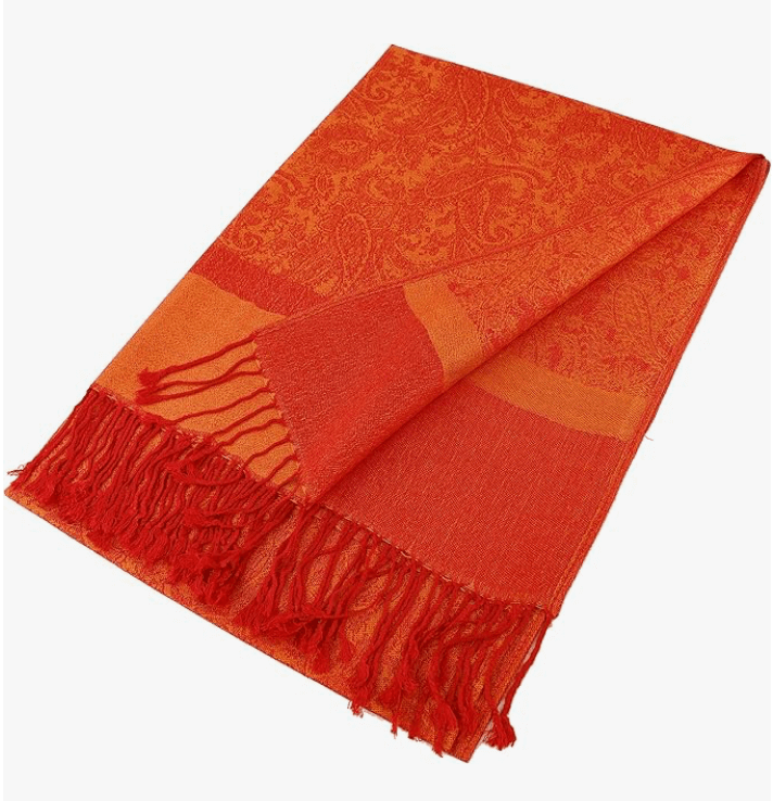 Vibrant orange pashmina with intricate patterns and hand-knotted tassels, perfect for cozy elegance.