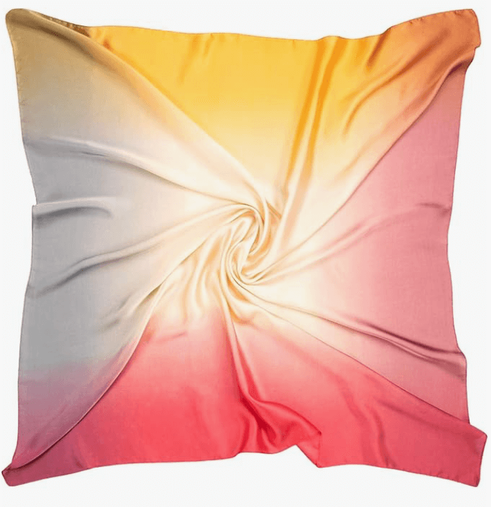 Luna Satin Headscarf in a gradient of yellow to pink, showcasing a glossy finish and soft satin texture.