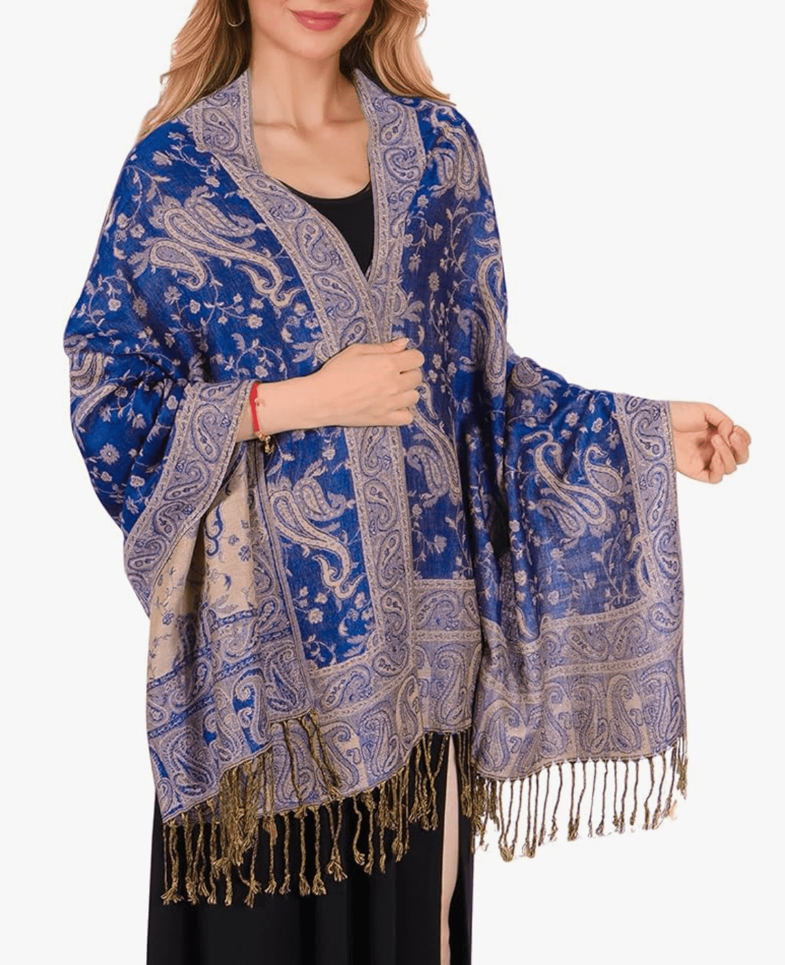 Woman wearing a luxury blue and gold pashmina shawl with intricate patterns and fringe detail.