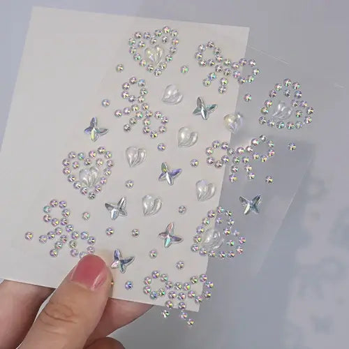 Stargirl Sparkle Gems in star, heart, and cosmic shapes on a clear sheet showcasing iridescent rhinestones.