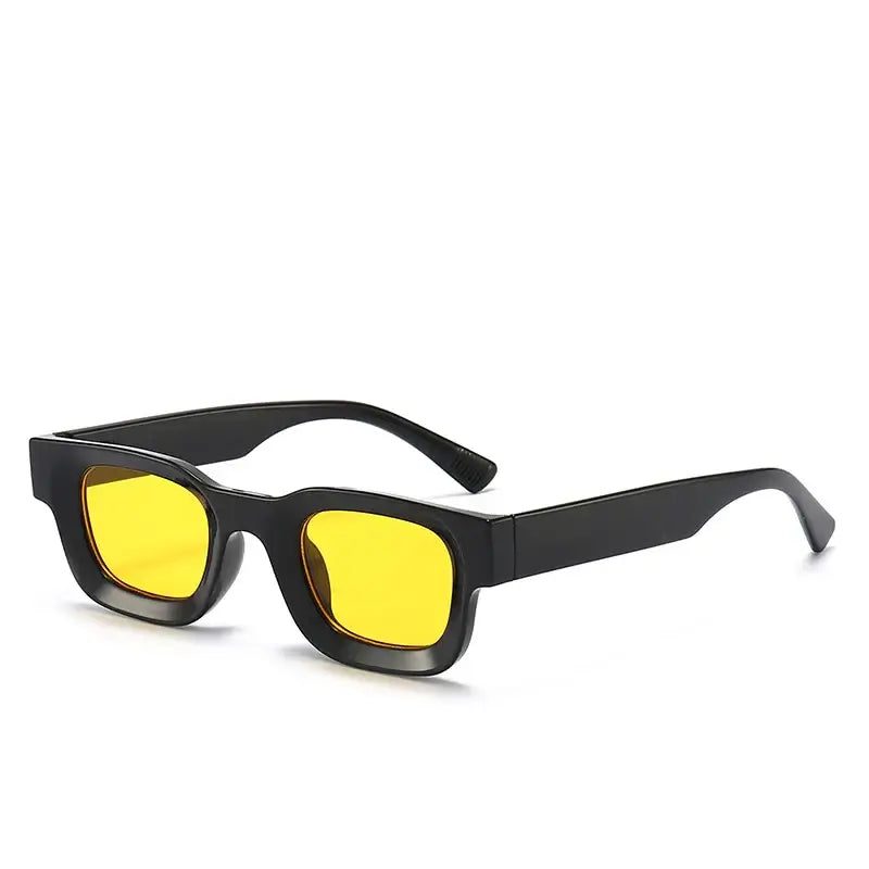Bold block sunglasses with retro frames featuring yellow lenses and a stylish black design.
