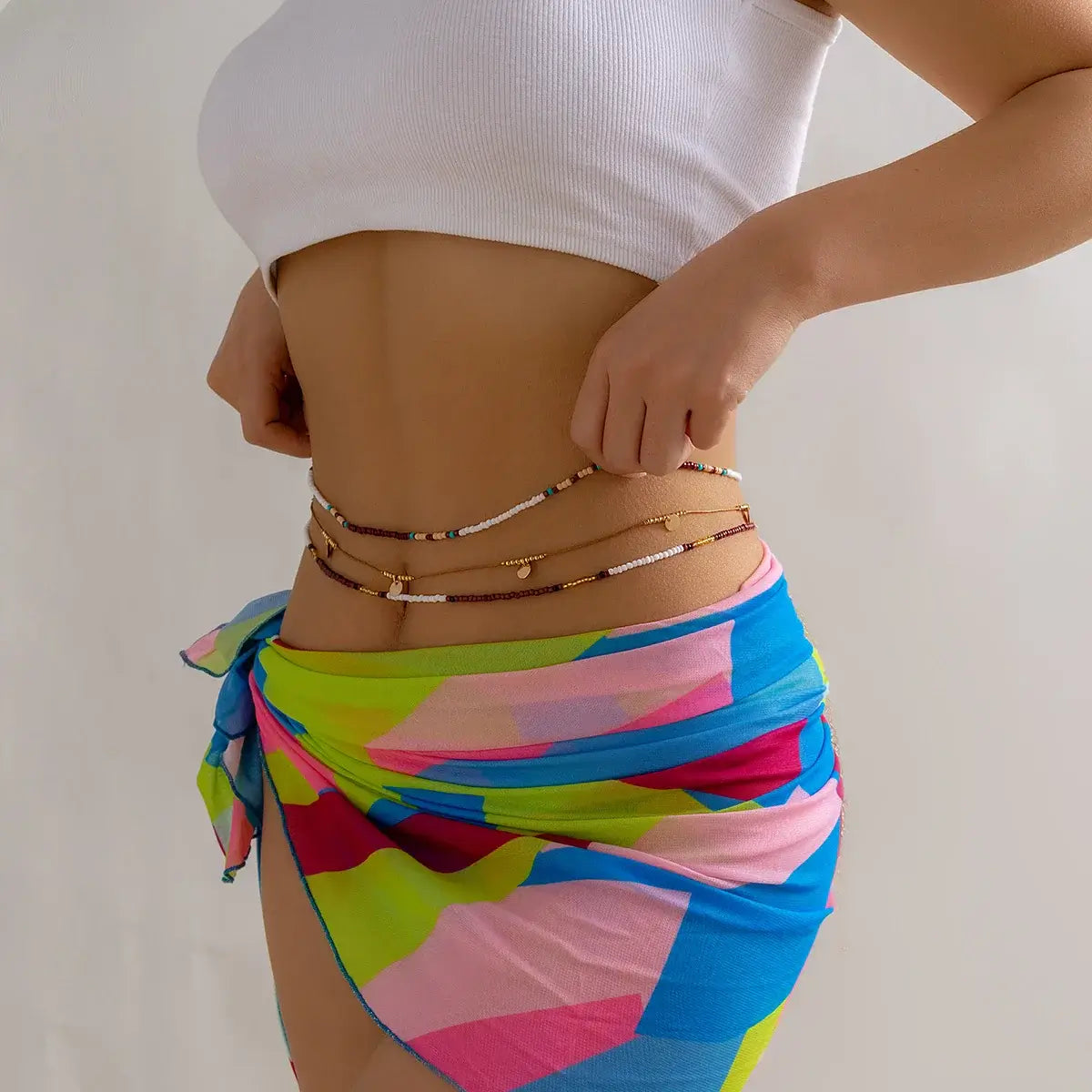 Model showcasing the Boho Beats Beaded Waist Chain with vibrant colors and gold accents, perfect for festivals.