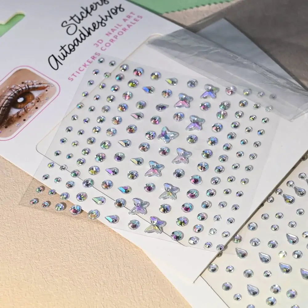 Stargirl Sparkle Gems featuring colorful holographic rhinestones in various shapes on a protective sheet.