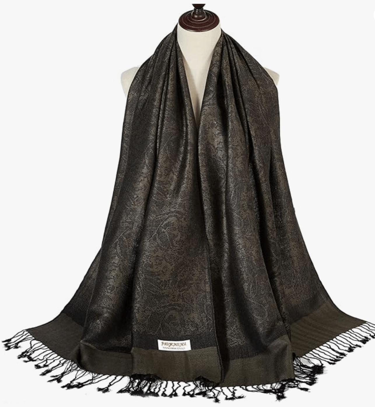 Elegant dark patterned pashmina scarf draped on a mannequin showcasing luxurious fabric and fringed details.