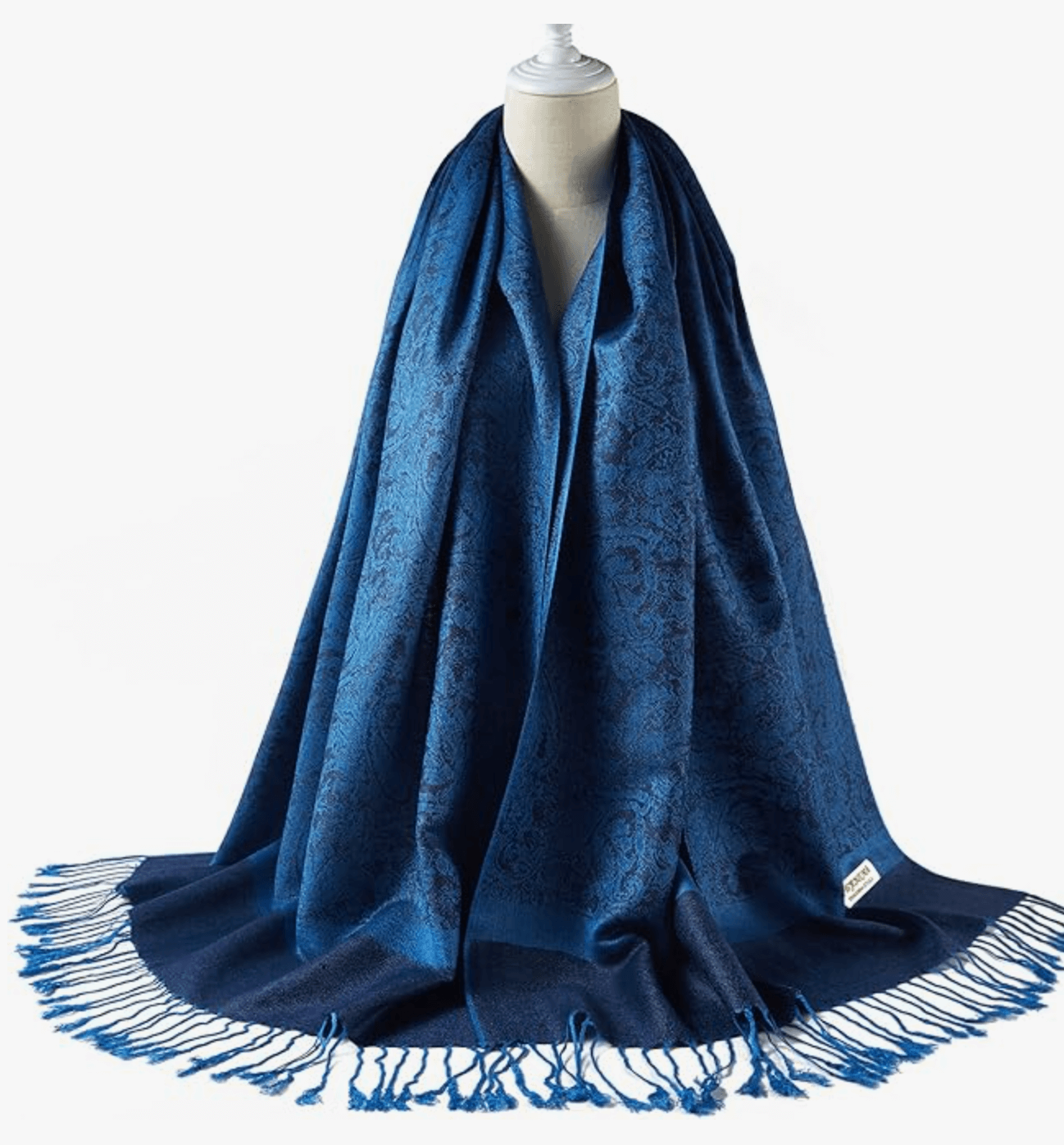 Elegant blue pashmina wrap displayed on a mannequin, showcasing intricate patterns and fringed edges.