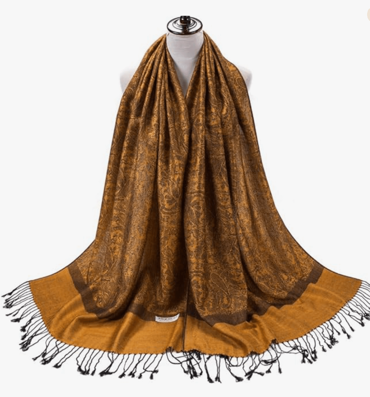 Elegant golden-brown pashmina shawl with intricate patterns and fringed edges, perfect for stylish layering.
