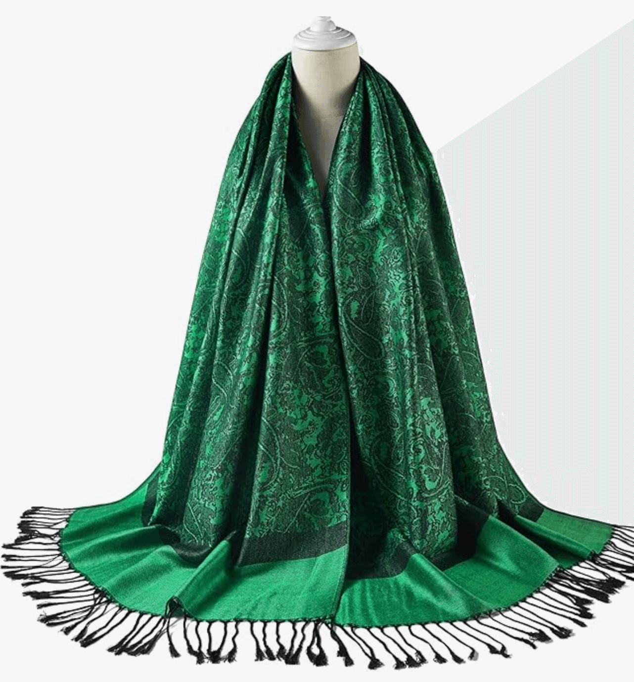 Luxurious green pashmina shawl with intricate patterns and fringed edges, perfect for stylish warmth.