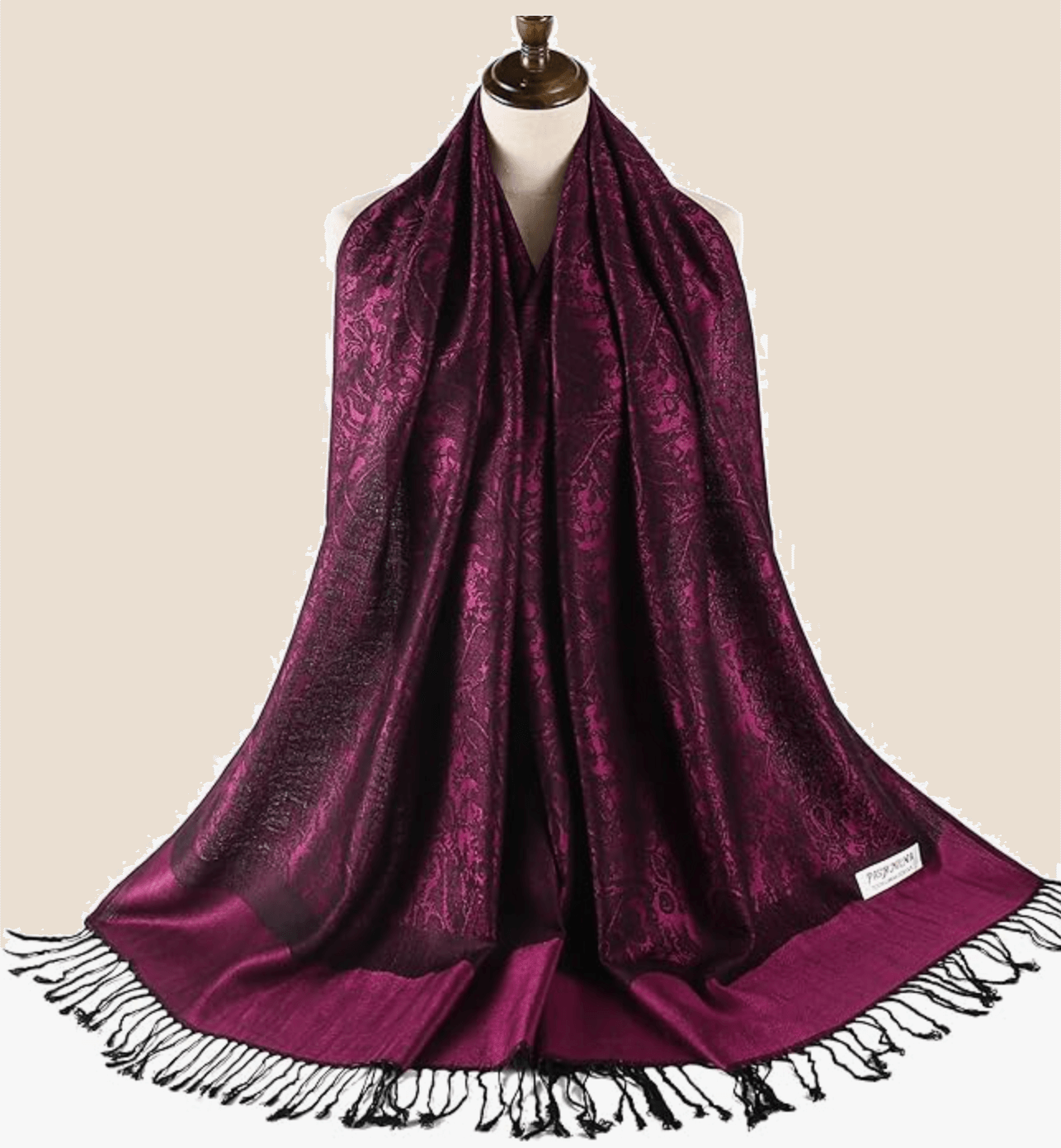 Elegant dark purple pashmina scarf with intricate patterns and fringed edges, perfect for stylish layering.