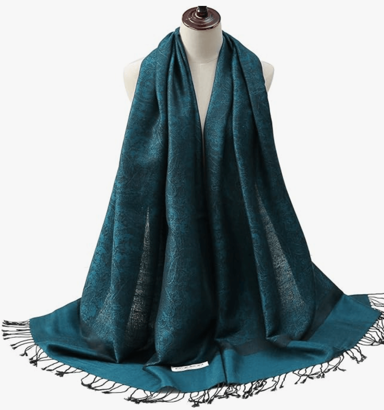 Teal pashmina shawl draped elegantly on a mannequin, showcasing intricate patterns and fringed edges.