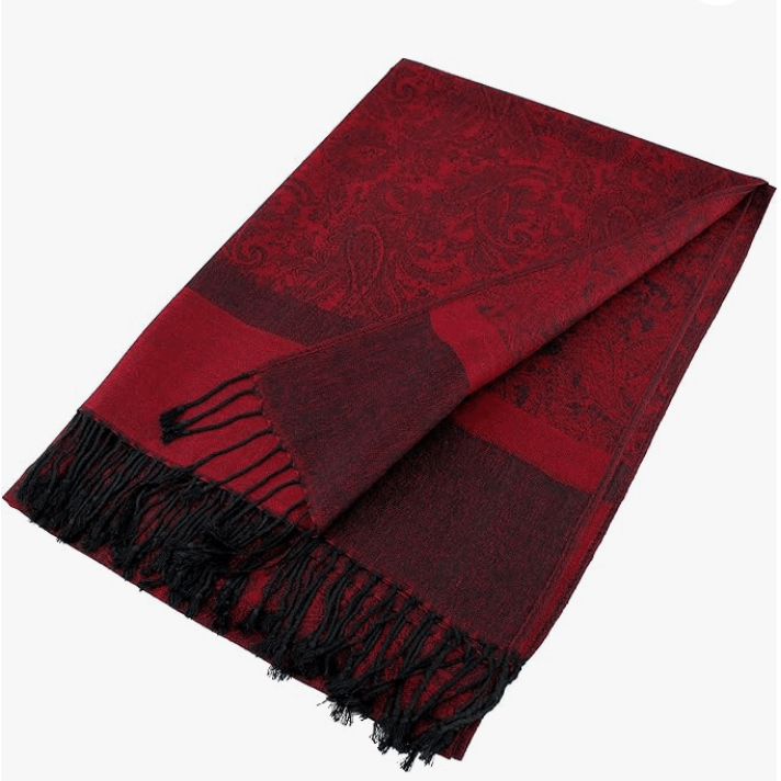 Celestial Luxe Pashmina in rich red with intricate patterns and hand-knotted tassels, perfect for elegant layering.