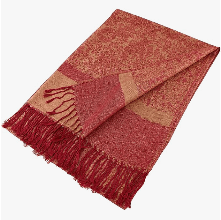 Celestial Luxe Pashmina in rich red tones with intricate patterns and hand-knotted tassels, perfect for elegant styling.