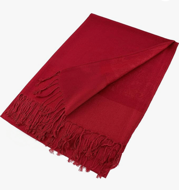 Celestial Luxe Pashmina in rich red color, elegantly draped and featuring hand-knotted tassels.