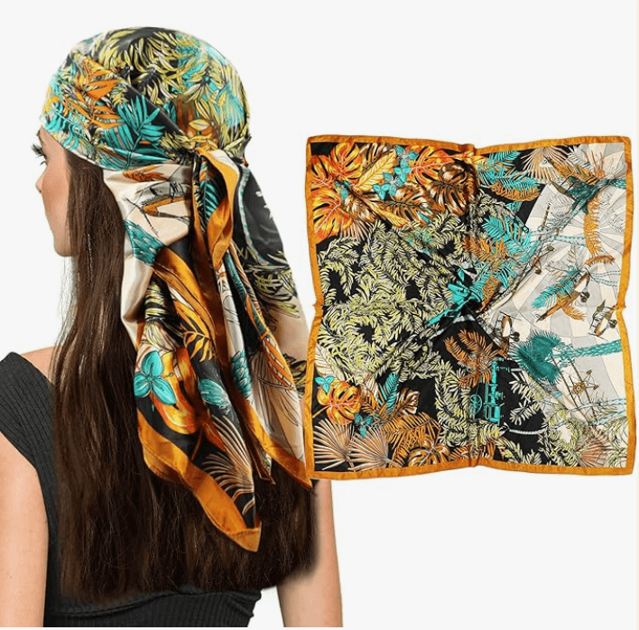 Eclipse Luxe Satin Scarf in vibrant tropical design, worn as a head wrap, showcasing its smooth fabric and stylish look.