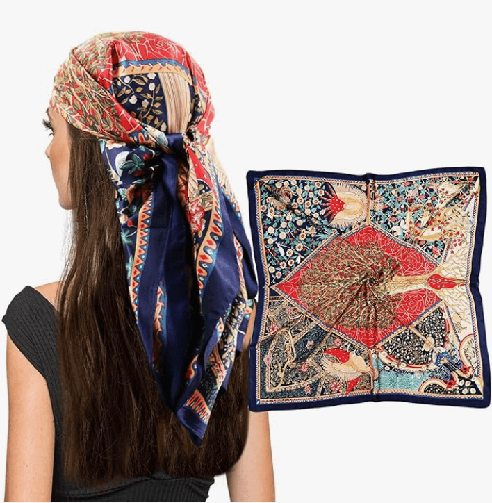 A woman wearing a colorful scarf on her head, showcasing intricate patterns and vibrant colors.