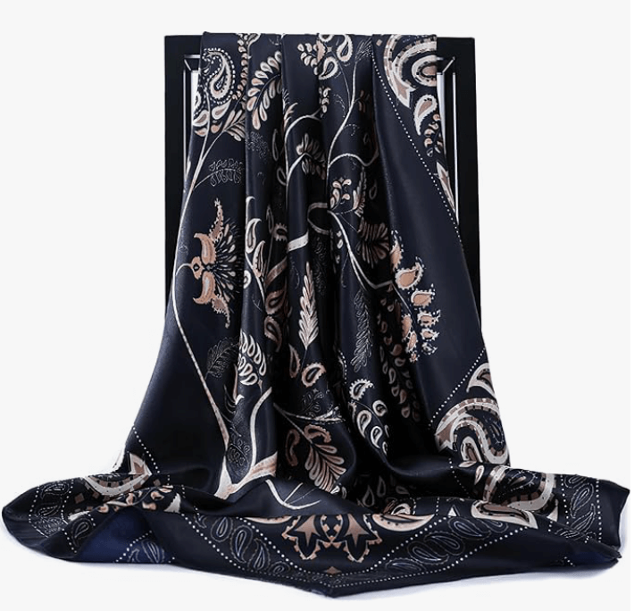 Eclipse Luxe Satin Scarf in navy with floral design, showcasing soft and stylish fabric draping elegantly.