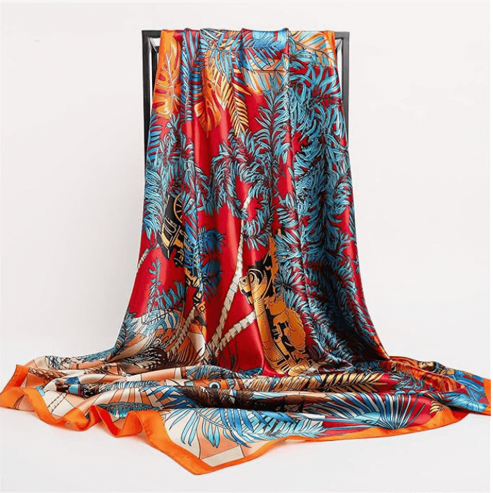 Eclipse Luxe Satin Scarf featuring vibrant palm leaves and tigers on a red background, soft and stylish for any occasion.