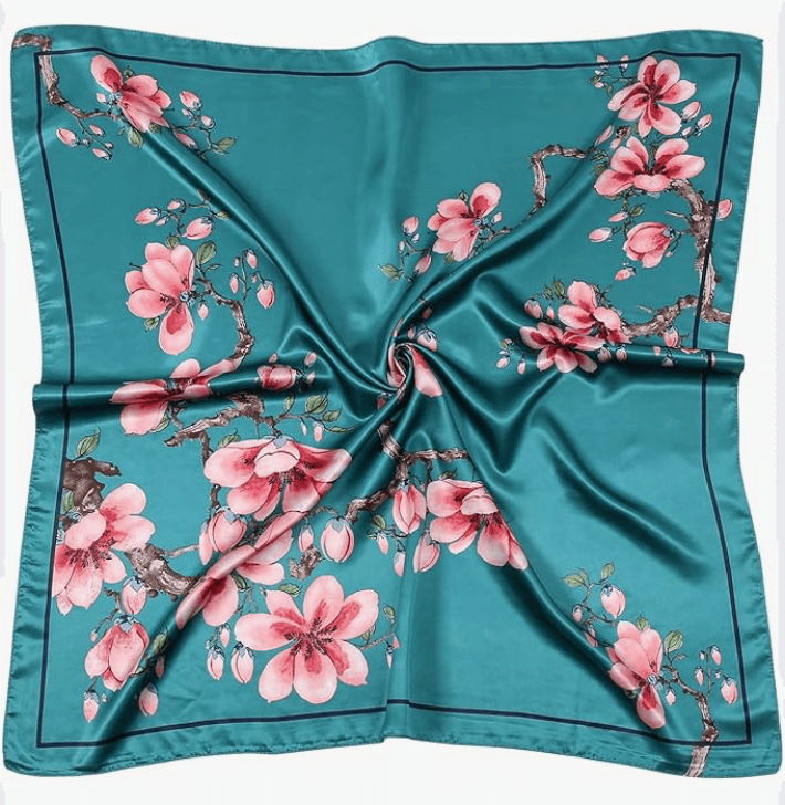 Luna Satin Headscarf featuring a vibrant teal color with blooming pink flowers in an elegant design.