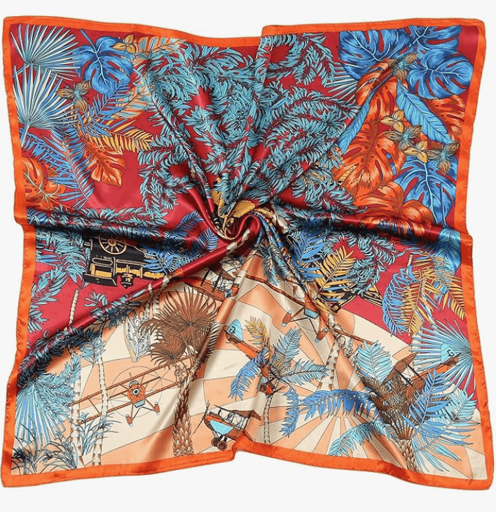 Vibrant Luna Satin Headscarf featuring lush tropical patterns in red, blue, and orange hues.