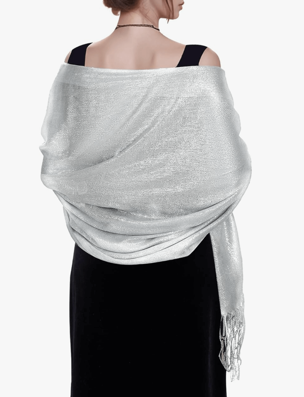 Woman wearing a silver sparkly pashmina wrap, showcasing its shimmer and elegant draping.