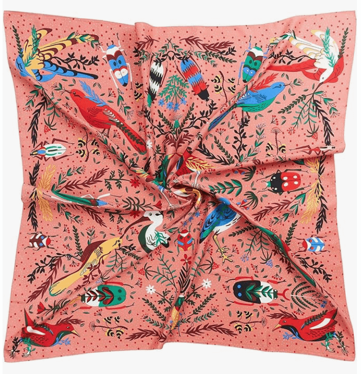 Starluxe Satin Headscarf featuring vibrant floral and bird designs on a coral background, ideal for stylish accessories.