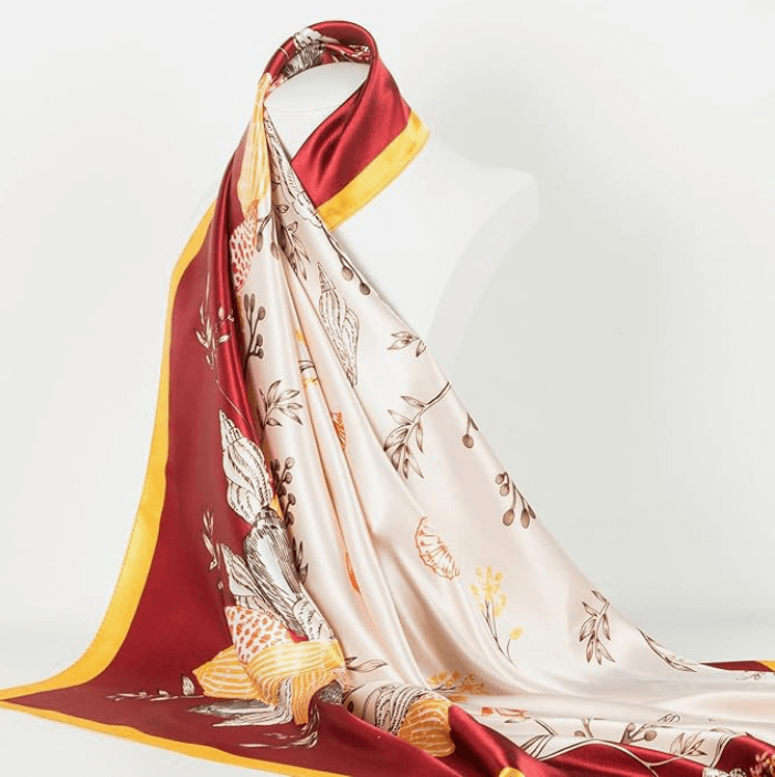 Veloura Satin Headscarf showcasing floral design in rich burgundy and gold accents, perfect for versatile styling.