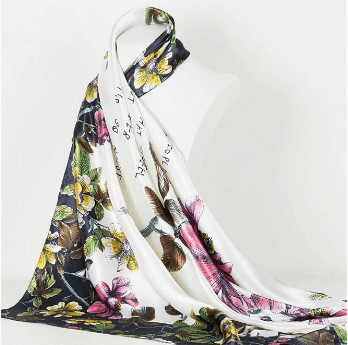 Veloura Satin Headscarf featuring a floral design, draped elegantly on a mannequin for stylish looks.