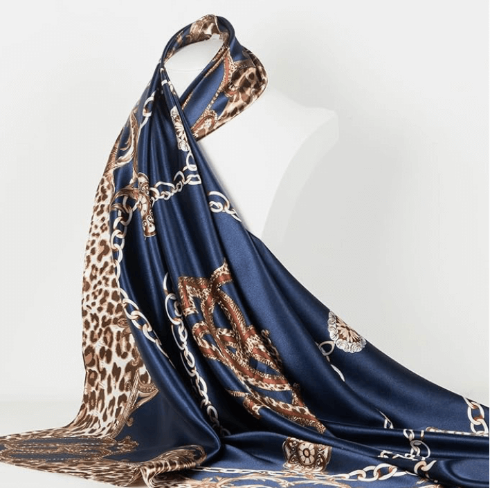 Veloura Satin Headscarf featuring a luxurious navy and leopard print design, perfect for versatile styling.