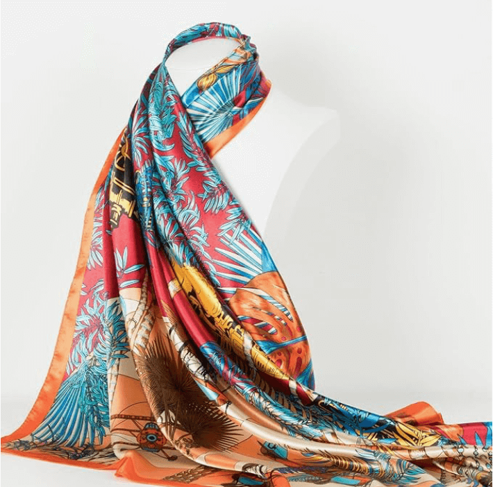 Vibrant Veloura Satin Headscarf featuring tropical patterns, perfect for versatile styling and fashionable accessorizing.
