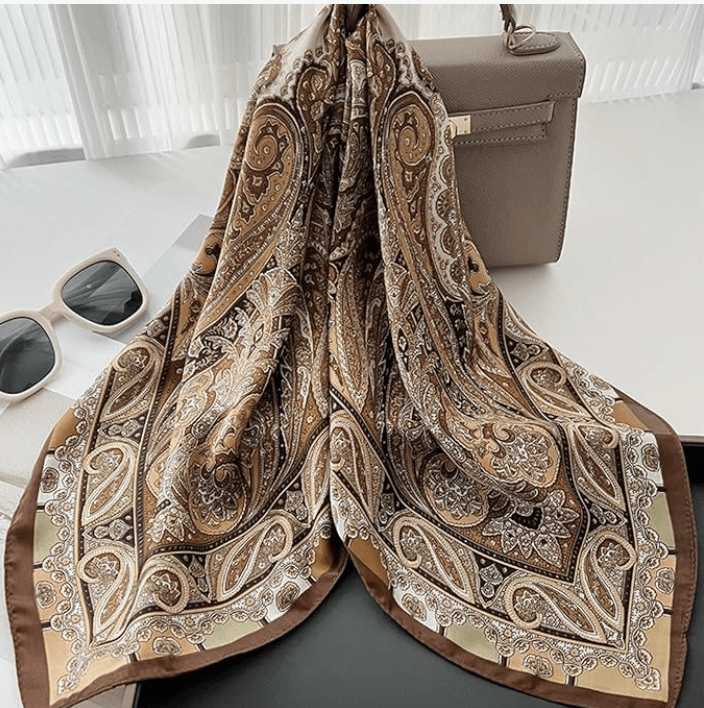 Vintage Luxe Satin Scarf in brown and gold paisley design with stylish sunglasses and handbag.