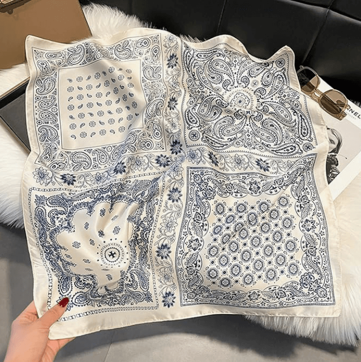 Vintage luxe satin scarf in navy and white with intricate patterns, perfect for festival styling and versatile wear.