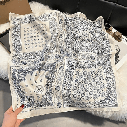 Vintage luxe satin scarf in navy and white with intricate patterns, perfect for festival styling and versatile wear.